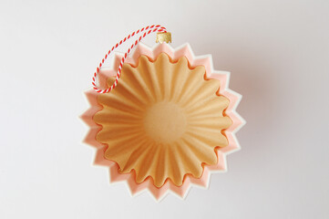 Origami dripper with wave paper filter for brewing coffee decorated as Christmas tree ball on...