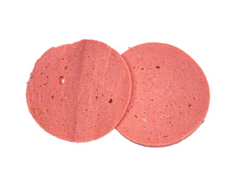 Slice of salami isolated on white background. Top view photo of raw salami.