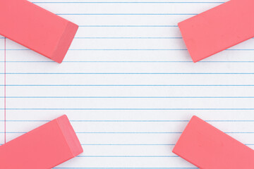 Notebook ruled paper with erasers background
