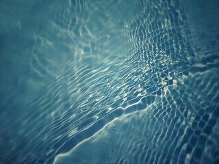 Defocus blurred transparent blue colored clear calm water surface texture with splashes and bubbles. Trendy abstract nature background. Water waves in sunlight with copy space. Blue watercolor shining