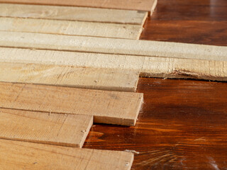 Textured wooden background. Light wooden planks on a dark lacquered table, shallow depth of field