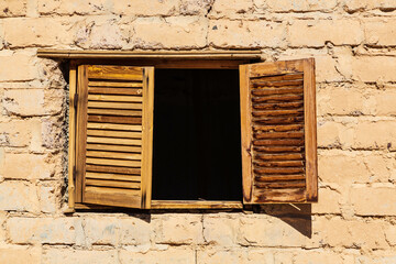 Wooden window on brick stone wall in a hut in Sinai desert, Egypt