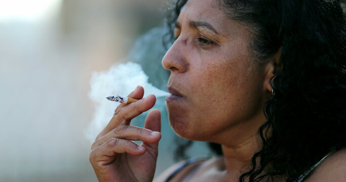 Hispanic Anxious Woman Smoking Cigarette