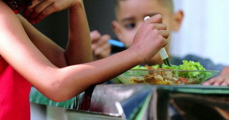 Children eating plate of salad, kids eat lunch