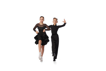 Dance couple. Two kids, school age girl and boy in black stage costumes dancing ballroom dance...