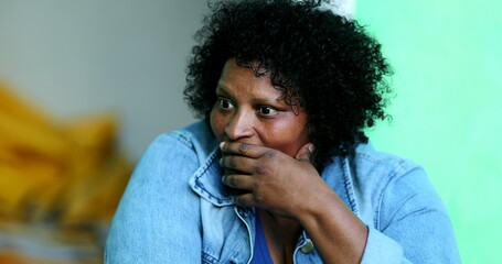 Candid black woman smiling, real casual emotion. Satisfied African lady