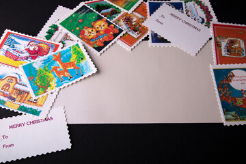 envelope on the table with a postcard and stamps