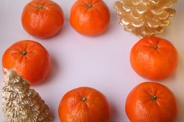 GROUP OF TANGERINES LYING ON A WHITE BACKGROUND