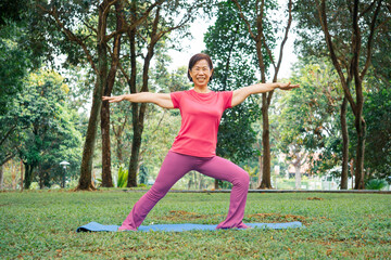 An elderly woman doing yoga and meditation in a park 