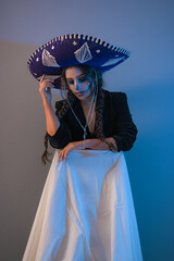 Portrait of a woman wearing beautiful Day of the Dead costumes and skull makeup