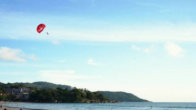 Tourists parasailing flying sky during sunset mountain background. Summer holiday vacation concept.