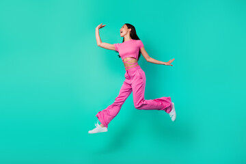 Fototapeta na wymiar Full length profile side photo of active energetic female feel free jumping up isolated on teal color background