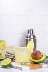 Classic refreshing alcoholic sweet and sour cocktail,  boozy Avocado and lime margarita shot drink with salt, Cinco de Mayo or mexican party ideas recipe