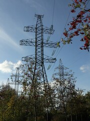 High voltage  line tower on blue sky background as electricity collection