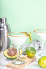 Boozy refreshing avocado alcoholic drink. Avocado martini cocktail, with lime, vodka, green hot chili peppers