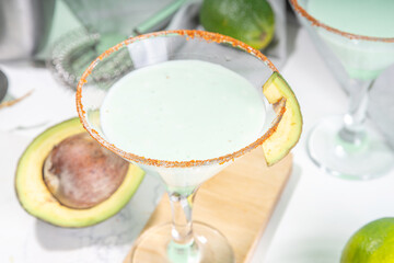 Boozy refreshing avocado alcoholic drink. Avocado martini cocktail, with lime, vodka, green hot chili peppers