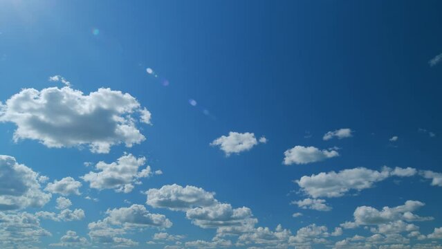 Summer blue sky and white clouds background. Layers of cloud space. Blue sky fluffy white clouds on summer season. Time lapse.