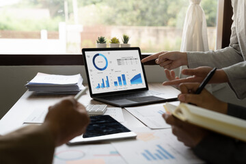 Business team brainstorming data target financial on laptop computer and paperwork