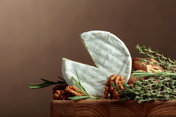 Brie cheese with walnuts, thyme, and rosemary.