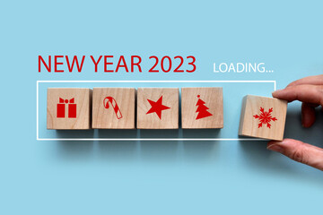 Wooden cubes in the form of batteries with drawings of Christmas icons. The new year is coming...