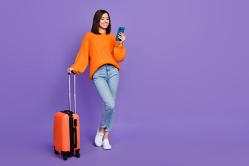 Full length photo of charming young lady hold telephone gps maps wear trendy orange knitwear...