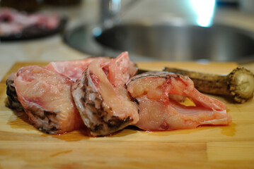 Cooking fish at home, slicing.