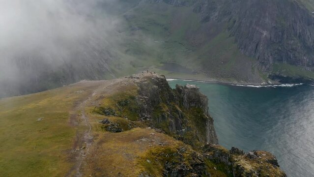 Aerial view of the Ryten summit in the Lofoten Islands in Norway in summer on a cloudy day. Color graded