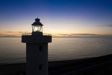 Fototapeta na wymiar Aerial view of a maritime lighthouse taken at night