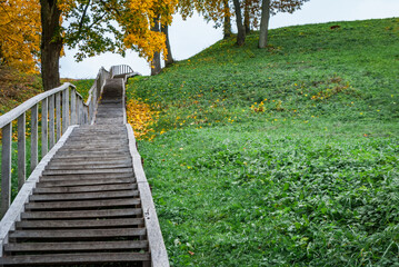 Fototapeta na wymiar Steps of a high wooden staircase leading to Dubingiai Hill, Lithuania