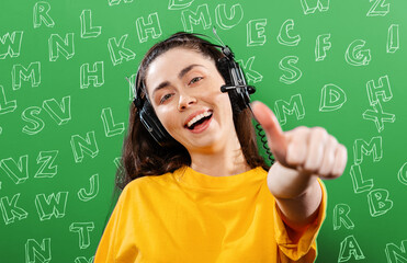 Language learning and listening.Portrait of a young smiling woman wearing headphones, giving a...