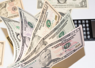 Canculator on the photo of money. calculate the cost of a car trip