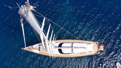 Aerial drone top down photo as seen from top of mast of beautiful sail boat with wooden deck...