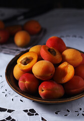 Fresh ripe apricots in bowl in rustic style