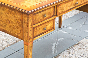 Detail of an old carved italian wooden table with drawers  just restored
