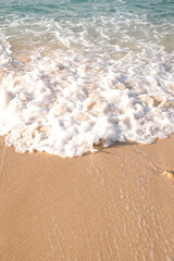 Top view of sand sea and wave. Holiday concept with sea and sand. Sea foam and sand. Holiday phone screen background.