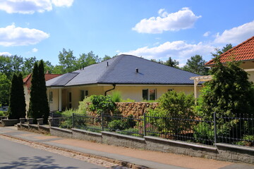 The roof of a house is newly covered with slate