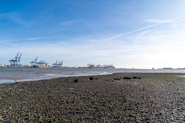 Feliistowe Suffolk UK February 1st 2022 Container Port from Opposite Inlet showing Container Ships and container handling gantry cranes