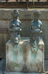 Germany, Wismar - July 13, 2022: Closeup of Nix und Nixe statues on Wasserkunst, Duch renaissance monument built on top of natural water source. Faucets are dry here. - obrazy, fototapety, plakaty