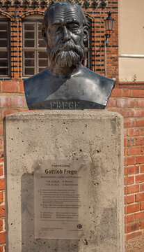 Germany, Wismar - July 13, 2022: St. Marienkirche. Closeup of Gottlob Frege bust statue on east side of grounds. Red bricks as backdrop.