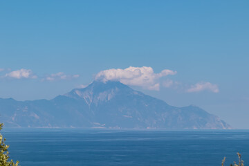 Panoramic early morning view of cloud covered holy Mount Athos from Fava sand beach, Vourvourou,...