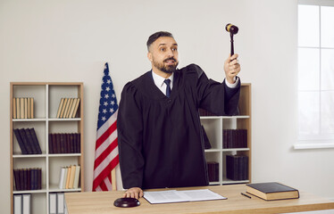 Middle-aged Caucasian male attorney in mantle strike gavel pronounce verdict or sentence in...