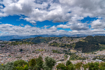 Fototapeta na wymiar In Quito, Ecuador, almost everyone lives on the hillside, and the colorful houses and the green Andes mountains form a special urban landscape.