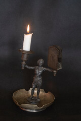 Obraz na płótnie Canvas sculpture of a woman holding a candle, a candlestick. burning candle