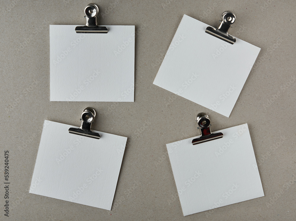 Wall mural white blank paper notes with metal clips, isolated on gray textured board surface, note or messages 