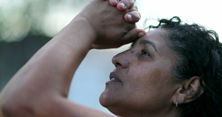 Hispanic woman praying to God, spiritual latin south american person