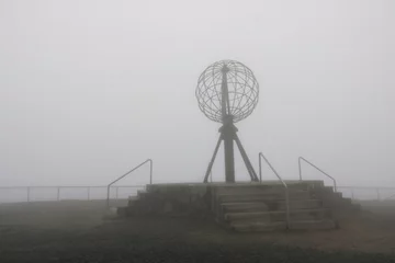 Fototapete Rund the Nordkapp North Cape globe symbol on a foggy day © Dynamoland