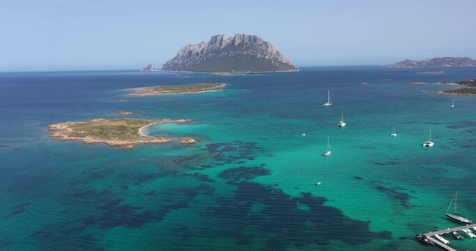 Aerial view of Tavolara Island surrounded by a clear and turquoise sea in Sardinia, Italy.
