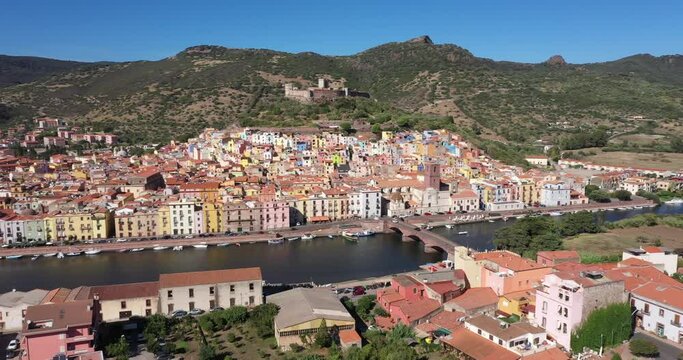 Aerial view of the beautiful village of Bosa with colored houses and a medieval castle on the island of Sardinia, Italy