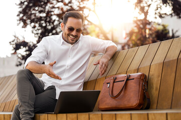 Businessman using laptop outdoor