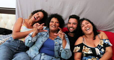 Hispanic latin people laughing and smiling, south american family together in home sofa